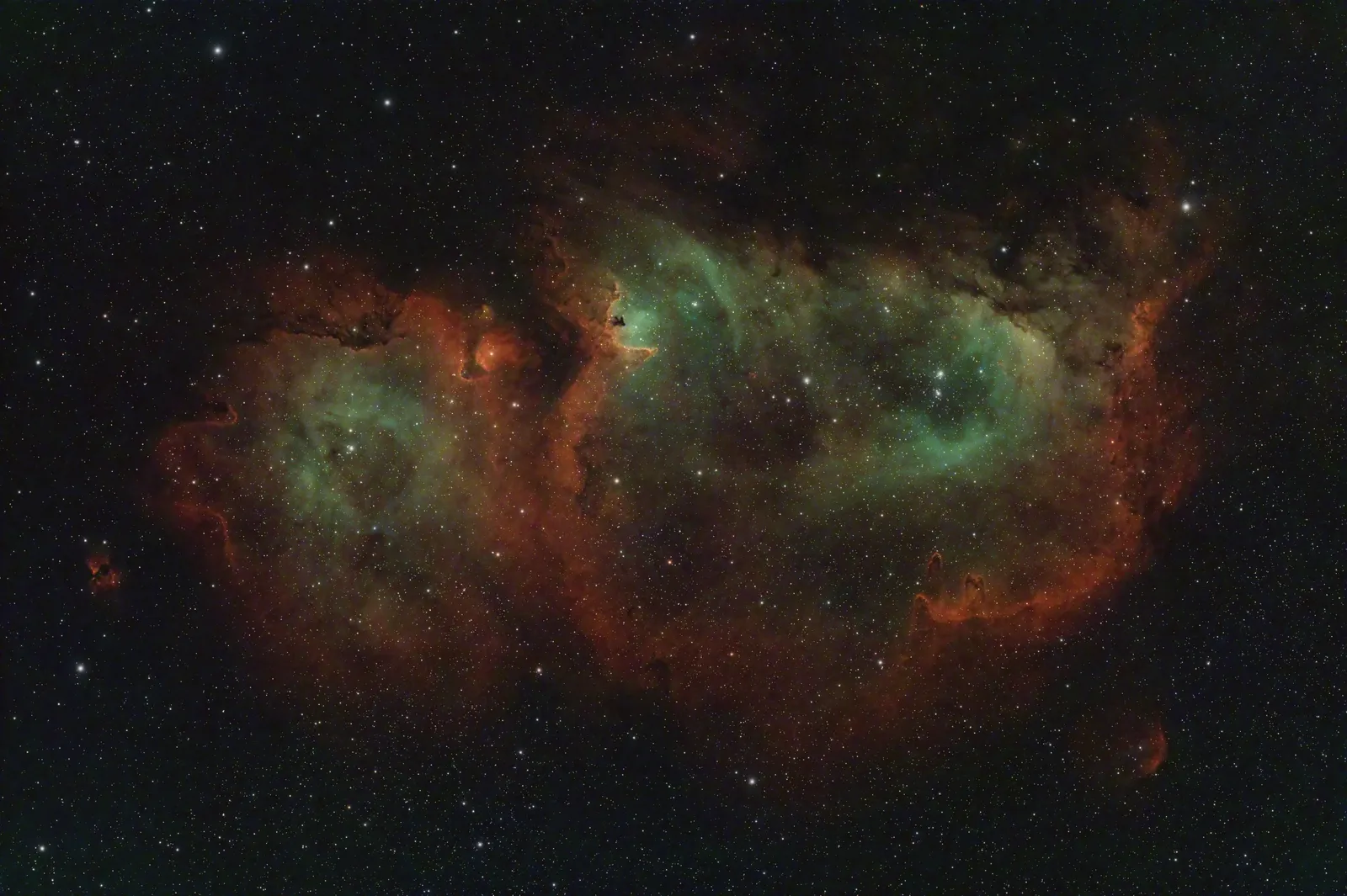 IC 1848, the Soul Nebula, an emission nebula in Cassiopeia with red and teal gas clouds and dark dust lanes