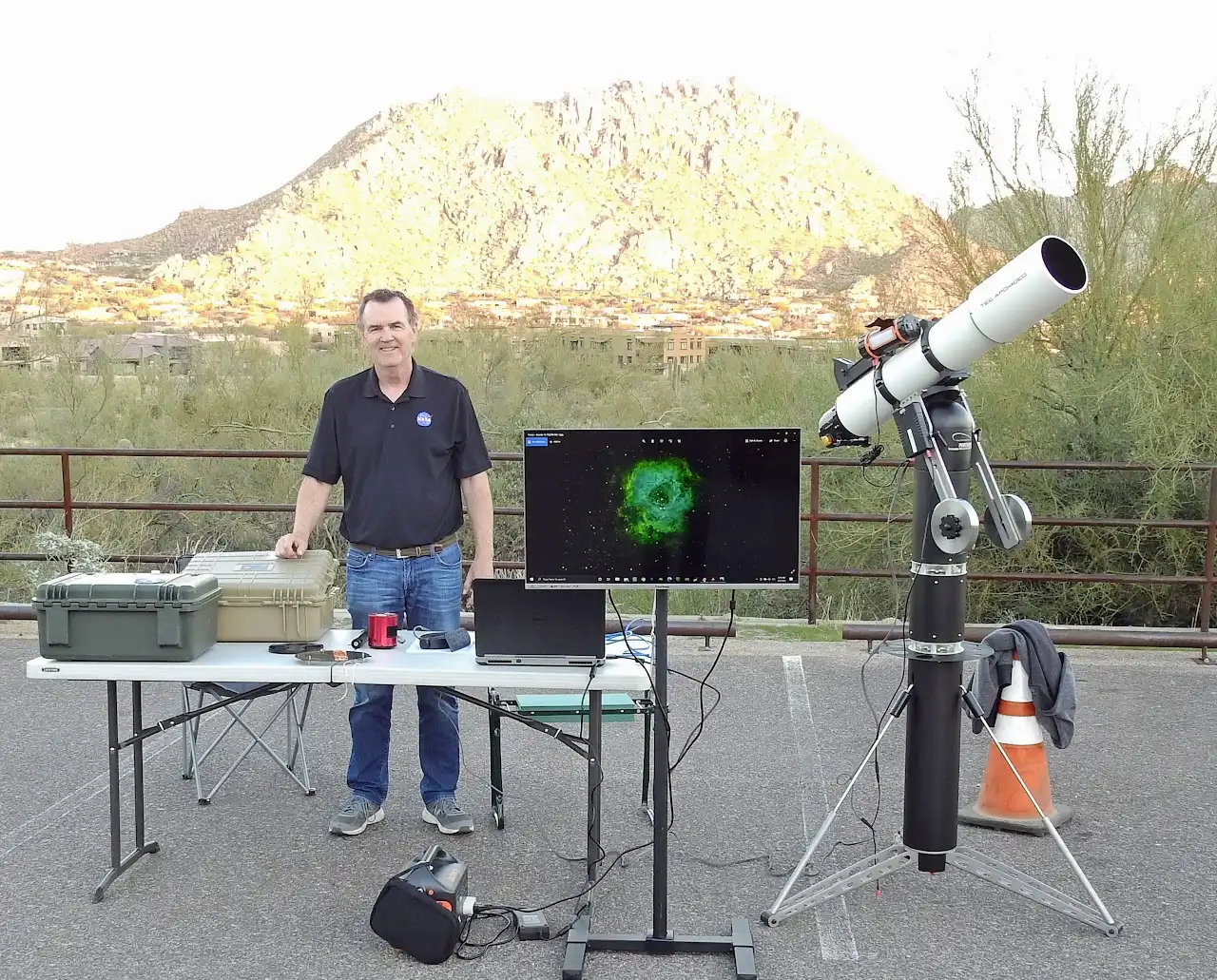 A PAS member showing visitors a telescope setup at a daytime outreach event