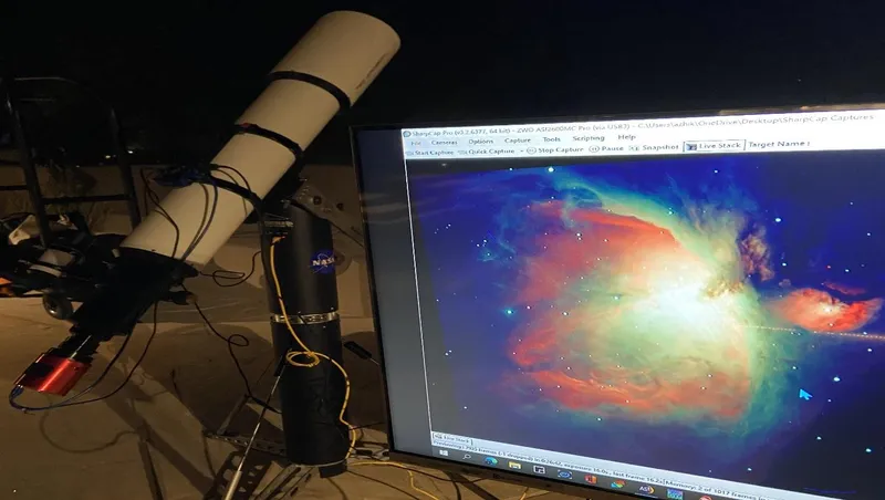 An EAA telescope live-stacking the Orion Nebula onto a monitor at night