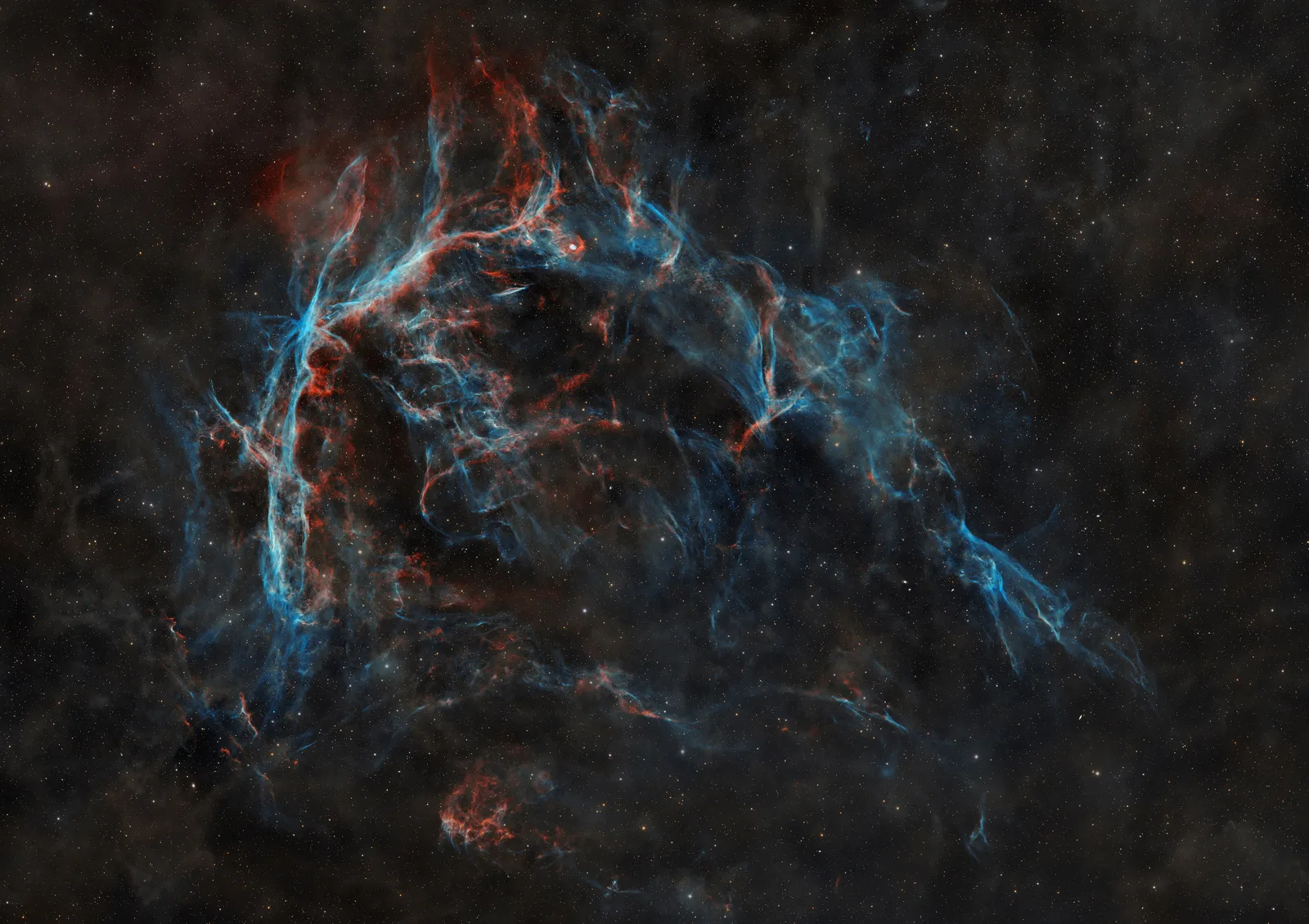 CTA-1, a faint supernova remnant in Cepheus, seen as delicate blue and red filaments against a starfield